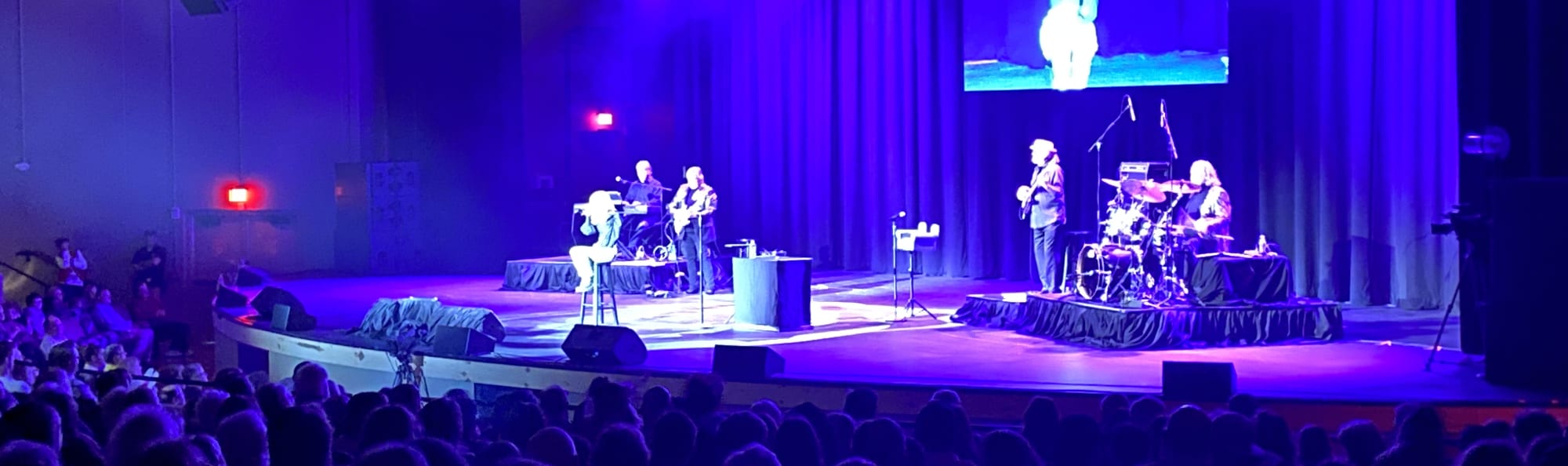 signer on stage in chair washed out by the lights Daytona Beach